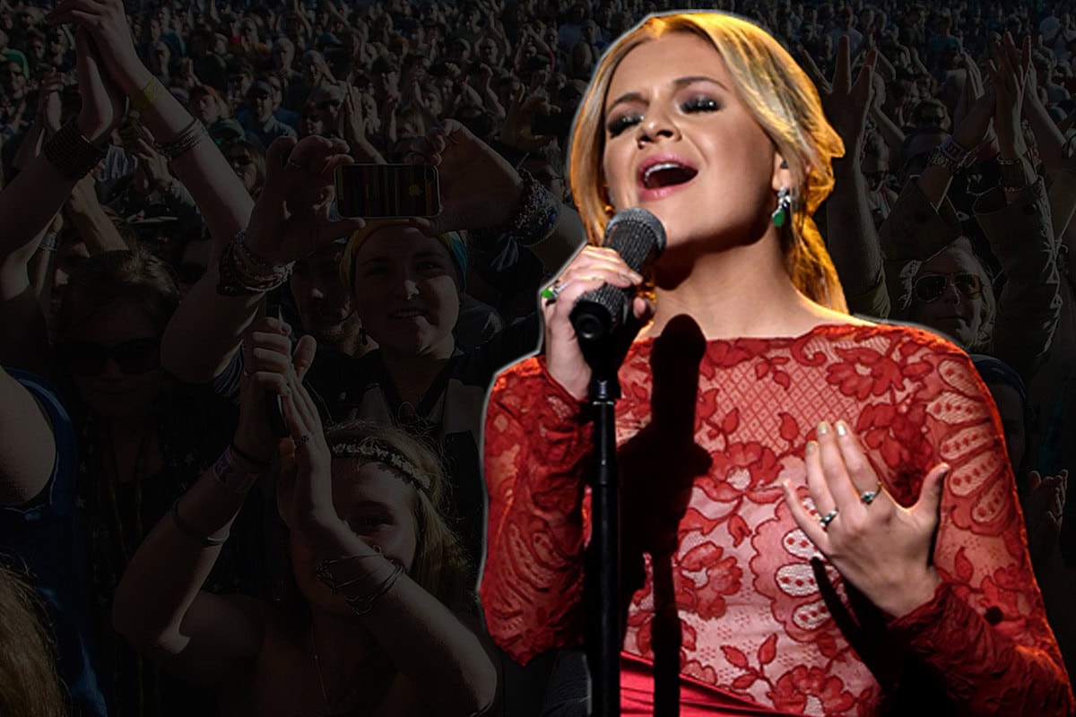 Female singer performing at a concert with an enthusiastic crowd.